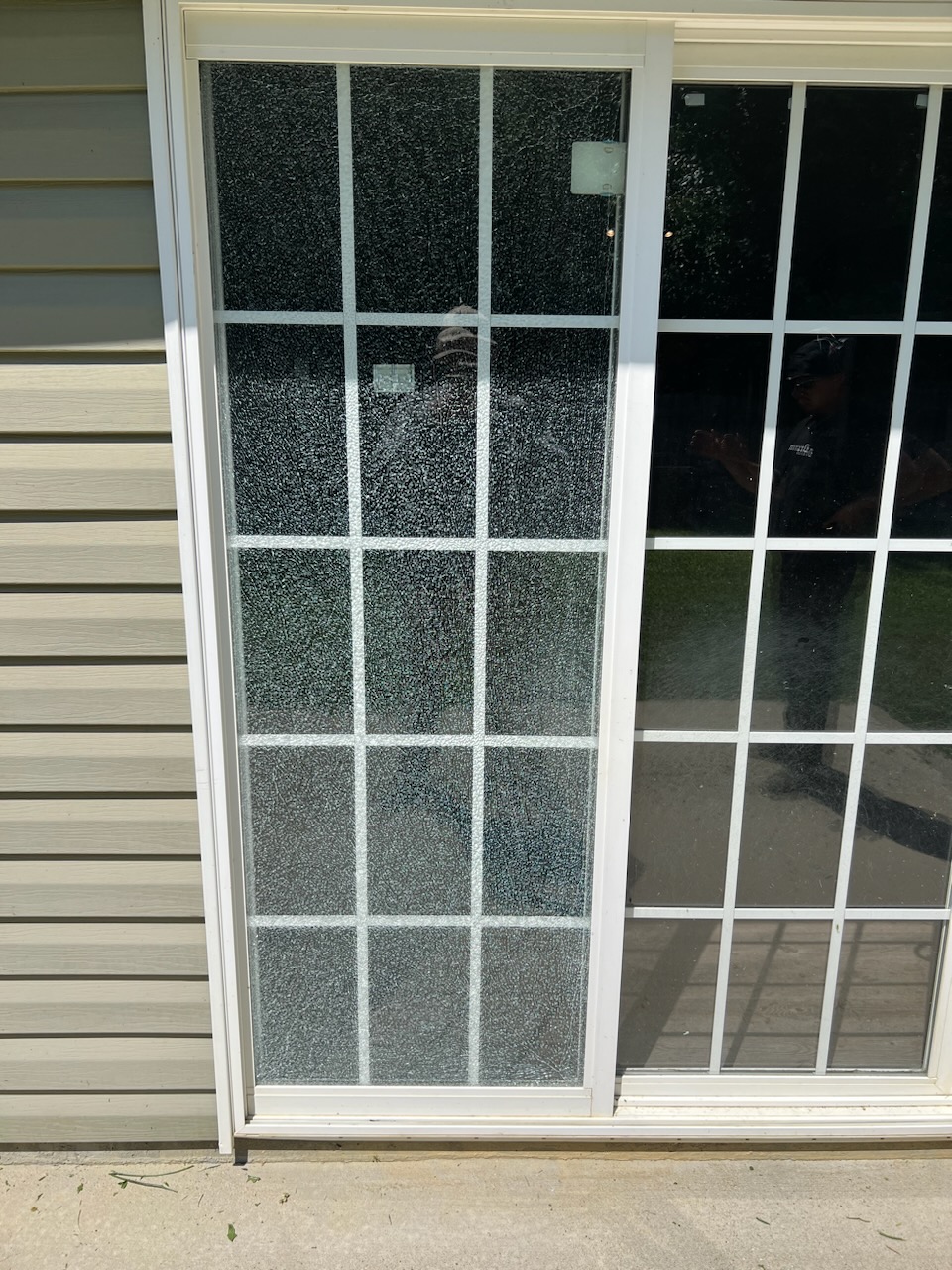 A shattered sliding door panel before replacement