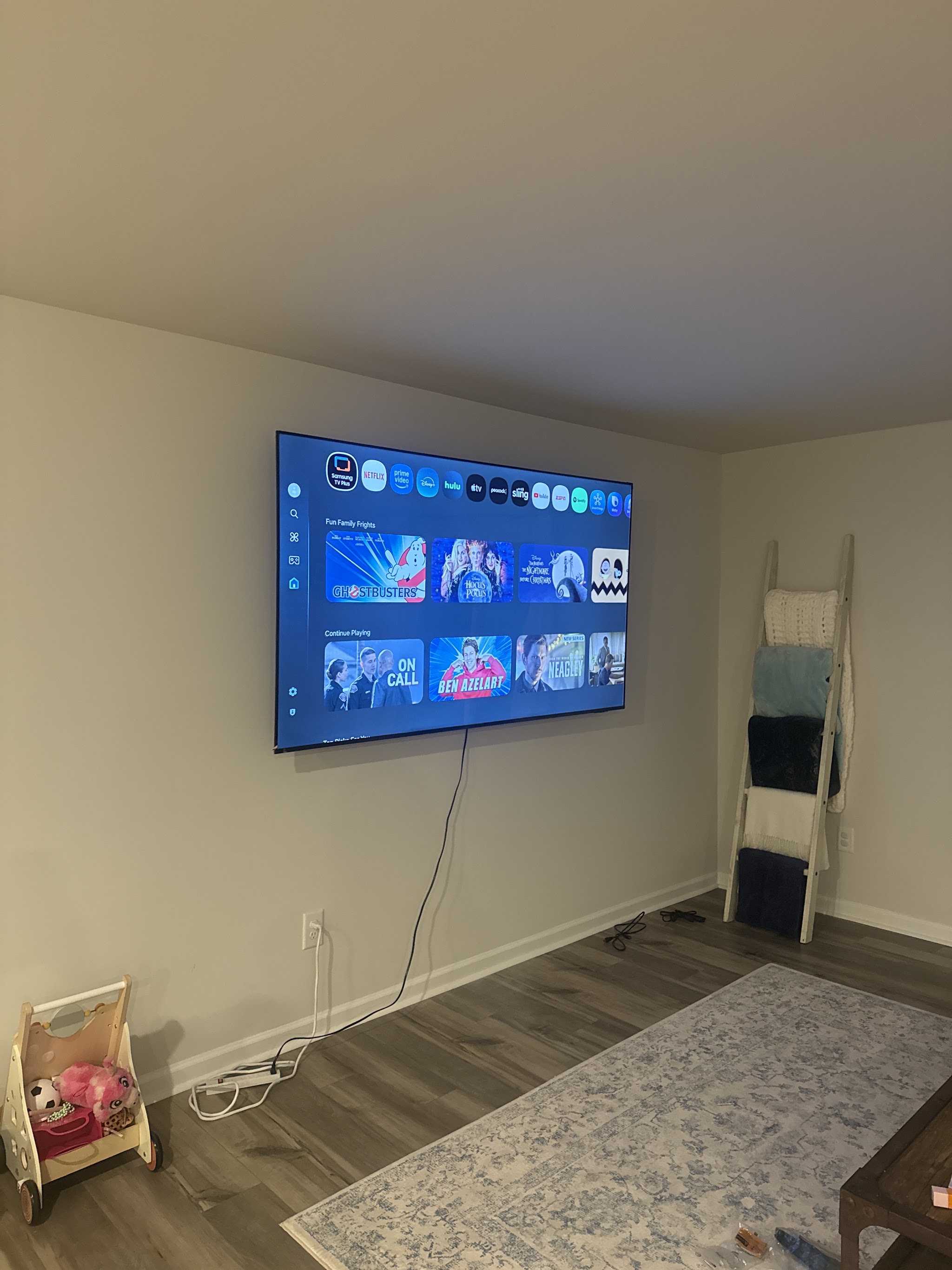 A wall-mounted television with the cable kept tidy